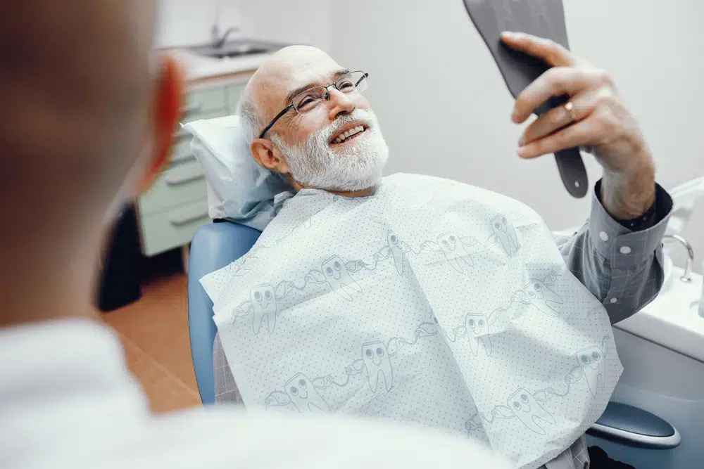 Man looking at his smile after dental appointment