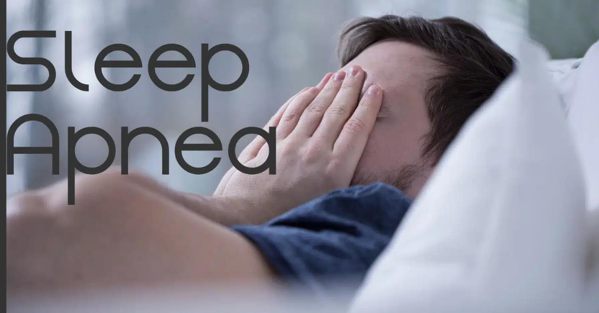 Person with hands on face unable to sleep due to sleep apnea.